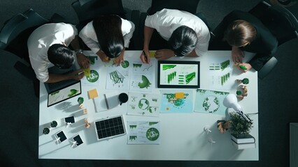 Top view of executive manager hold tablet display clean energy at meeting. Aerial view of business...
