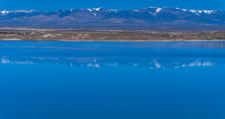 Cuesta del Viento reservoir with andean mountains and blue lake in San Juan, Argentina