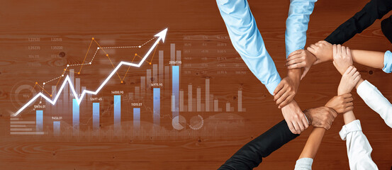 This image depicts a diverse group of hands coming together above business graphs, emphasizing teamwork and collaboration essential for achieving growth and success. Scalp