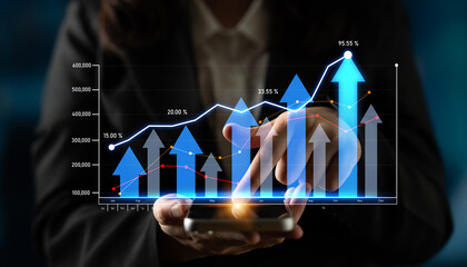 Business professional analyzes impressive profit growth using a smartphone while graphical overlays display increasing percentages and data trends in a modern workspace. Scalp