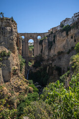 Vertical Scenery of Cliffside Town Ronda in Andalusia. City on a High Rock. Puente Nuevo during Sunny Day in Spain. Historical Bridge in Province of M&aacute;laga.