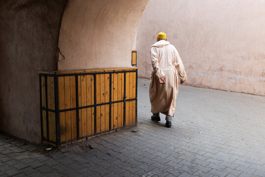 MARRAKESH, MOROCCO - DECEMBER 4, 2025: Locals and tourists going on with their daily business in Marrakesh old medina streets and traditional markets, part of Unesco world heritage
