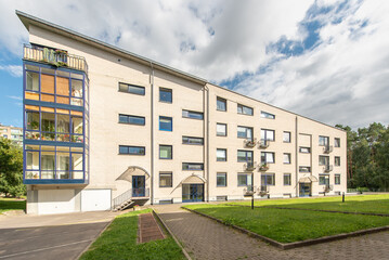 Obraz premium Modern Residential Building With Courtyard Surrounded by Greenery and Trees