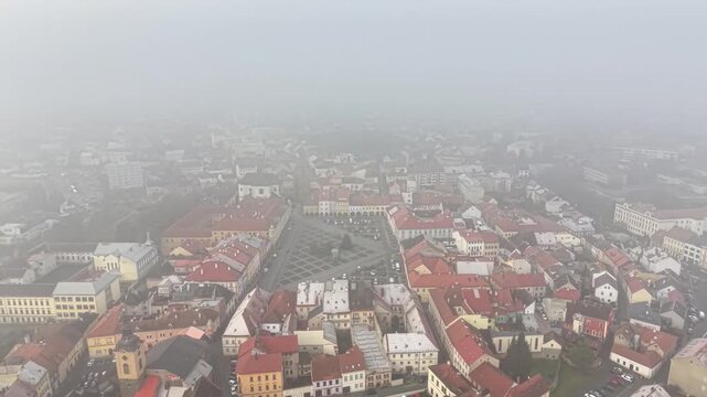 aerial foggy civic square with patterned plaza and surrounding municipal buildings, cultural promotion shot