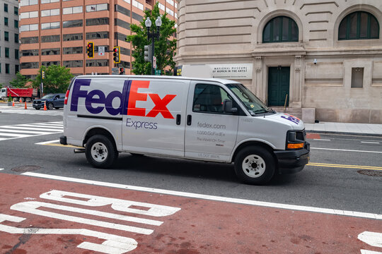 FedEx courier truck in residential neighborhood with cobblestones
