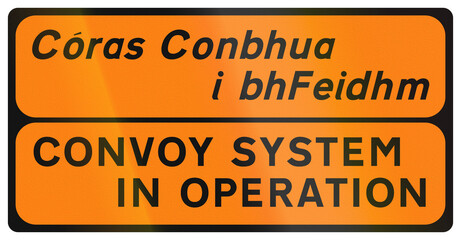 Temporary warning road sign used in Ireland - Convoy System in Operation in Gaelic and English