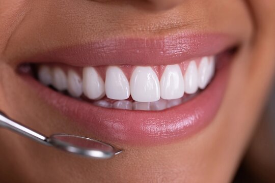 Smiling person during dental checkup with tools visible