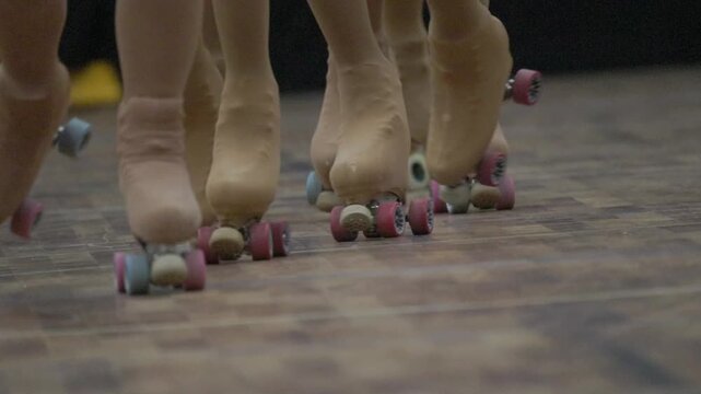 Group of people roller skating indoors at rink
