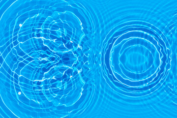 Blue water with ripples on the surface. Defocus blurred transparent blue colored clear calm water surface texture with splashes and bubbles. Water waves with shining pattern texture background.