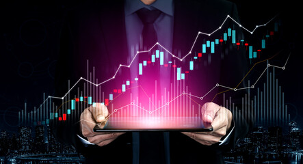 Businessman in formal suit holds a tablet displaying vibrant financial graphs, symbolizing financial growth and data analysis against a night city backdrop. Scalp