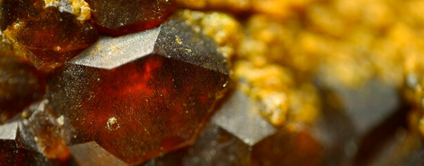 Macro shot of almandine garnet crystals with distinct cubic hexahedral symmetry, Dalnegorsk deposit, Russia. 4X magnification under micro lens