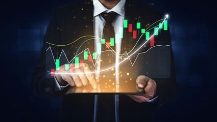 A business professional demonstrates financial data analysis using a tablet with stock market graphs, highlighting growth and investment opportunities in a modern office setting. Impute