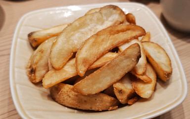 delicious fried dish baked potatoes on a plate