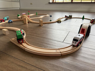 wooden toy trains on tracks, home floor playtime, concept of children toys, education