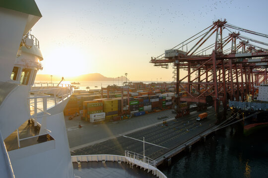 Callao, Peru - 20 Dec 2025: View From The Ship At The Flok Of The Birds Over The Callao Port During Sunset Overlapping The Mountain, International Container Terminal