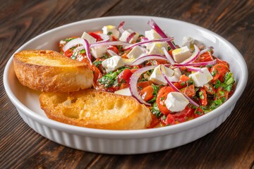 Roasted red pepper salad with feta red onion herbs and toasted crostini