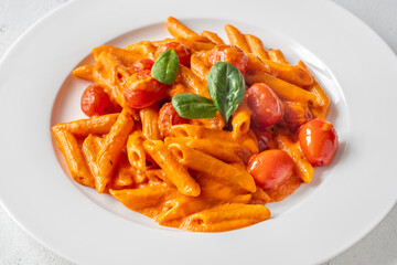Penne pasta with roasted bell pepper emulsion cherry tomatoes Parmesan and herbs