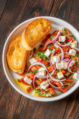 Roasted red pepper salad with feta red onion herbs and toasted crostini