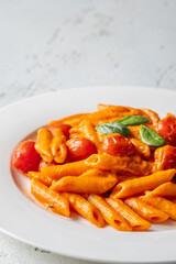 Penne pasta with roasted bell pepper emulsion cherry tomatoes Parmesan and herbs