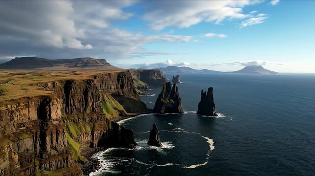 Dramatic drone view of rugged cliffs and sea stacks against a cloudy sky and deep blue ocean