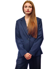 A woman in a black jacket and black pants poses for the camera. She has long brown hair and is wearing a necklace. Concept of professionalism and sophistication. White background. Fashion and beauty
