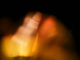 Abstract light leaks on dark background for design and special effects. Random form of color burst.