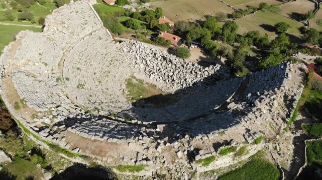 Drone view of ruined Roman amphitheater of ancient Selge city in mountain area of Altinkaya on sunny spring day. Archaeological and historical sights of modern Turkey 