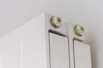 White radiator with bleeding valve detail for home heating