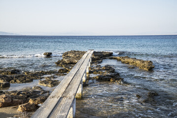 A wooden walkway into the Mediterranean Sea on the island