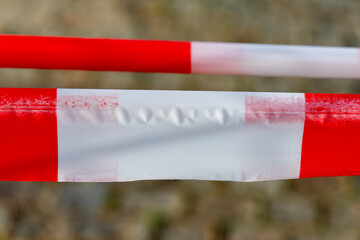 Red and white barrier tape marking restricted area