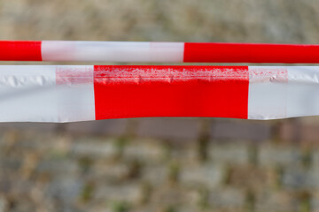 Red and white barrier tape restricting off-limits area