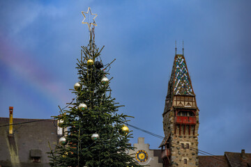 A rainbow and a Christmas tree at the Bremgarten Christmas market, Switzerland
