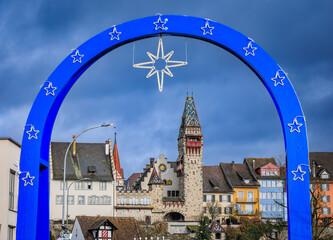 Blue star arch frames a medieval tower, Christmas market, Bremgarten Switzerland