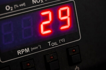 Digital emissions analyzer showing comprehensive measurement parameters including NOx oxygen RPM and oil temperature readings