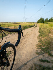gravel bike on dirt path through rural fields