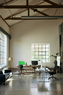 New tech office interior with computers on desks and large windows