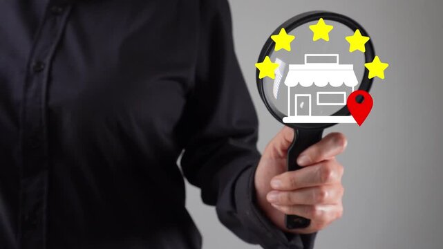 Close-up of a woman's hand with a magnifying glass examining a five-star review animation for a local business.