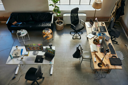 High angle view of office supplies on desk in startup tech hub