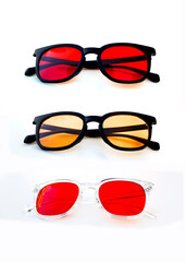 Modern eyewear with red and amber tinted lenses designed for blue light filtering, eye strain relief, and digital wellness, displayed in a clean studio setting.