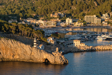 Fototapeta premium Beautiful striped lighthouse near the Port de Soller resort town Mallorca, Spain