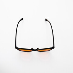 Amber tinted eyewear with black frame shown from above, ideal for daytime use to reduce digital eye strain and improve screen visibility.