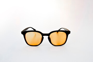Symmetrical product photo of amber tinted glasses with black frame, designed to reduce digital eye fatigue and enhance visual comfort.