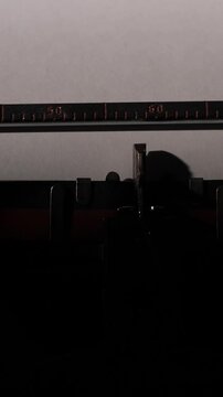 Vertical video vintage mechanical typewriter typing once upon a time. On a white sheet of paper, evoking nostalgia for traditional storytelling, creative writing, and literary endeavors