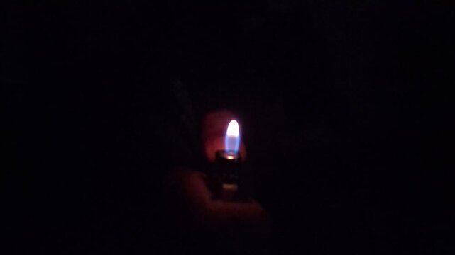 burning spark of a lighter in the dark, Ideal for B roll and Creative Projects. Fire or Flame Glowing in the darkness, Abstract Backdrop or Background For Hope, Faith and Passion. Mystery and Intrigue