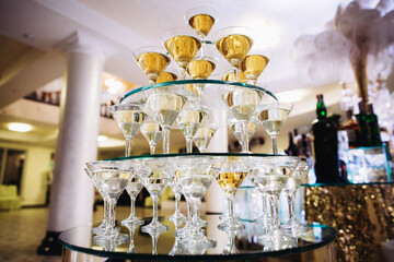 Champagne glasses forming pyramid at formal event party