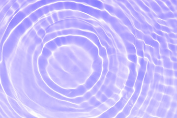 Purple water bubbles on the surface ripples. Defocus blurred transparent pink colored clear calm water surface texture with splash and bubbles. Water waves with shining pattern texture background