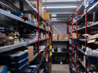Automotive parts storage with organized shelving displaying various components fluids and supplies...