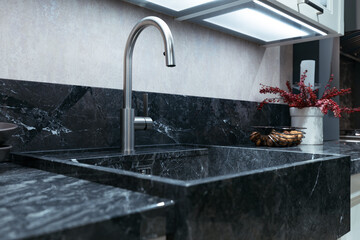 Stainless Steel Kitchen Faucet with Black Marble Sink and Countertop