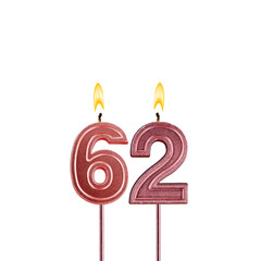 Lit birthday candle - Candle number 62 on white background