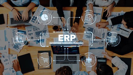 A dynamic team engaging in enterprise resource planning discussions, utilizing data charts and digital tools in a collaborative office setting. Focus on teamwork. Raster